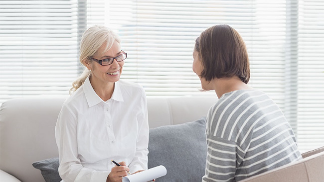 A provider meets with a client in a brightly lit room