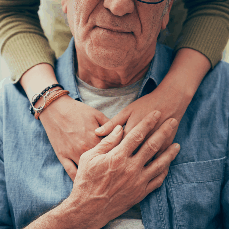 Comforting hand on shoulder of man