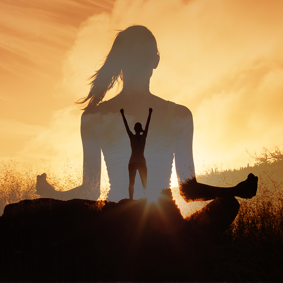 Silhouetted woman sits meditating in a peaceful landscape at sunset, image of an empowered person raising arms on a mountain top. Evokes strength, calm, and inner strength growth.